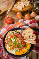 Homemade breakfast fried egg with tomato.