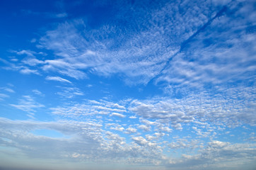 White clouds on the background of the blue sky