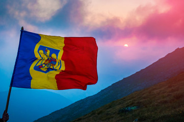 Romanian flag at sunset in the mountains