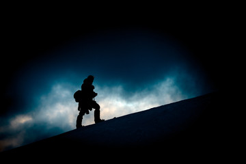Hiker silhouette in low key scenario