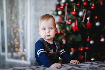 Beautiful child at the Christmas tree.