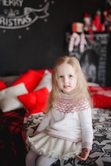 Lovely girl in purple dress in the background of Christmas decorations.