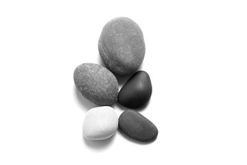 Fototapeta na wymiar Scattered sea pebbles. Smooth gray and black stones isolated on white background. Top view