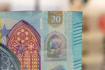 closeup of new banknote of twenty euros. out of focus in the background.