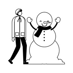 man with winter clothes and snowman