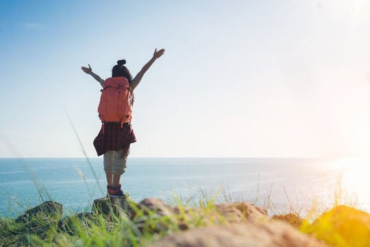 Adventure traveler woman with backpack joy relaxing in national park