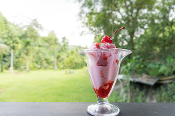 Delicious ice cream with one red cherry