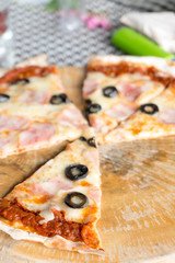 Italian pizza with ham olives and mushrooms