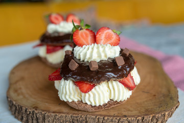 Chocolate pavlova with fresh strawberries and whipped cream