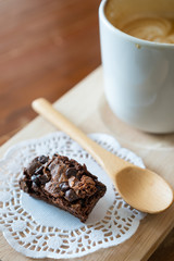 Chocolate brownie and Hot latte art coffee  on wood table