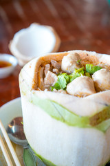 The noodles are served in a coconut.