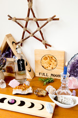 Full Moon Altar setup for ritual, with herbs, crystals, candle, moonwater  and branch pentagram