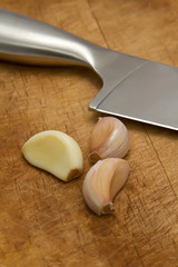 garlic and knife on cutting board