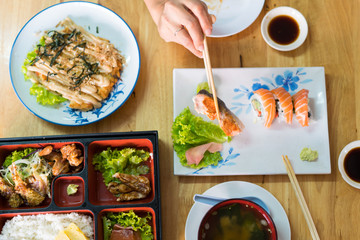 bento box with sushi and rolls janpanese food