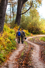 Fototapeta premium Fishermen go through the autumn forest. Western Siberia