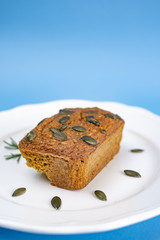 Gluten-Free pumpkin bread with pumpkin seed in white plate.