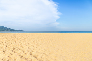 Fototapeta na wymiar Landscape view of empty tropical Mai Khao beach and blue sea under blue sky with white cloud 