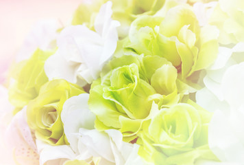 Obraz na płótnie Canvas Close up colorful of soft rose fabric artificial wedding flowers backdrop decoration