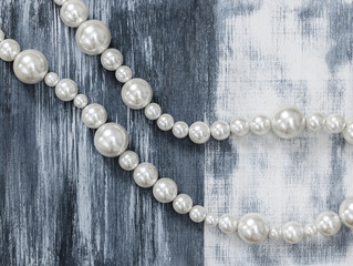 Pearl necklace on gray artistic background