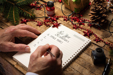 Old man writing new year resolutions