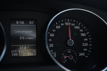 A Modern Car odometer Cluster with LCD Multifunction Display. Meter at constant speed show the fuel consumption efficiency 