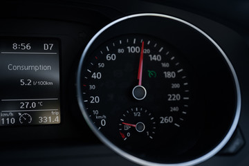 A Modern Car odometer Cluster with LCD Multifunction Display. Meter at constant speed show the fuel consumption efficiency 