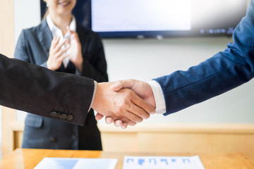 Close up of a business handshake, finishing up a meeting acquisition Greeting Deal concept.