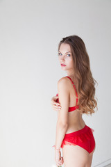 Fototapeta premium Portrait of beautiful fashionable woman in lingerie in the bedroom