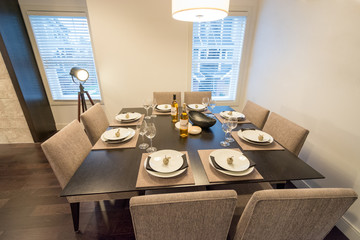 Bright dining room table set for dinner. Interior design.