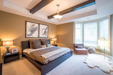 Fototapeta premium Modern bright bedroom interior with designer pillows in a luxury house, hotel.