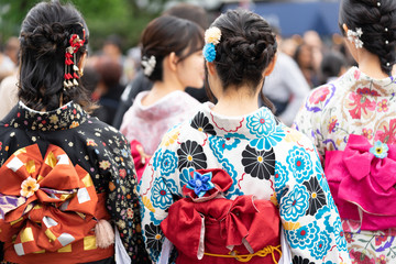 Young girl wearing Japanese kimono standing in front of Sensoji Temple in Tokyo, Japan. Kimono is a Japanese traditional garment. The word "kimono", which actually means a "thing to wear"
