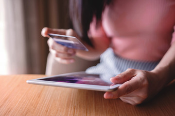 Woman Customer using Credit Card and Tablet to Shopping Online. Close-up shot and Selective focus