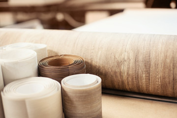 Rolls with brown wood texture. Production of doors