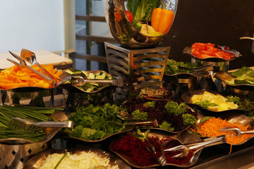lots of vegetables on the plates in the kitchen of the restaurant buffet