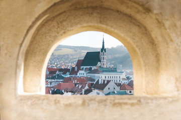 Beautiful view of architecture in Cesky Krumlov in the Czech Republic through a window or wall wall.