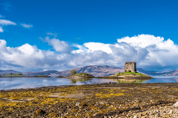 View of the Castle Stalker in autumn on the low tide near Port Appin, Argyll - Scotland