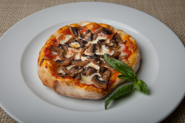 mushrooms pizza on a white plate