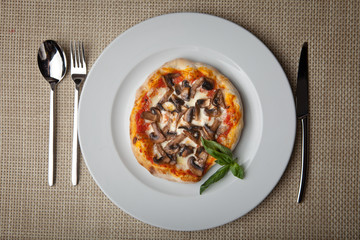 mushrooms pizza on a white plate