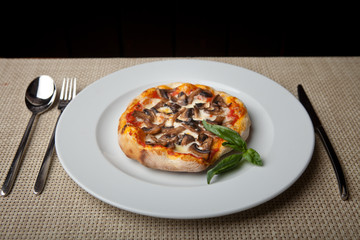 mushrooms pizza on a white plate