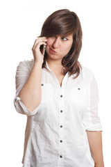 young woman making a face while on mobile phone call                               