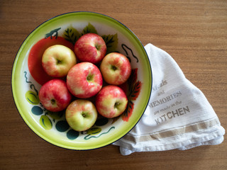 Vintage Painted Tin Bowl with Apples and Dish Towel from Above