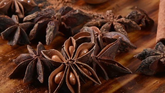 Star anise, cinnamon sticks and brown sugar on a cutting board