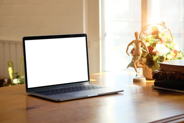 Mockup laptop computer on wood table.