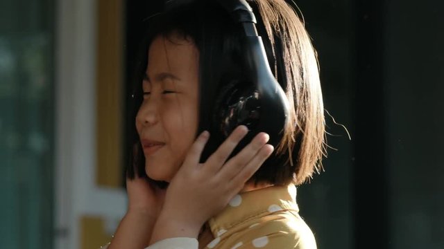 asian children wearing headphone listening music sound