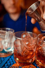  bartender prepares a  cocktail in the nightclub.