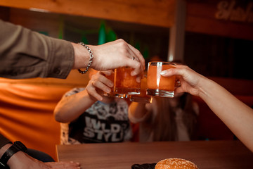 Clinking glasses with alcohol and toasting, party