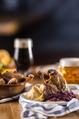 Roasted christmas duck leg red cabbage dumplings liver draft beer and baked buns