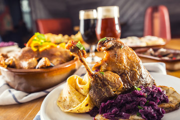 Roasted christmas duck leg red cabbage dumplings liver draft beer and baked buns