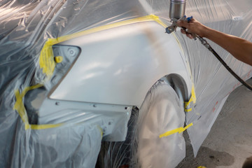 Car painting procedure at auto service store , Car accident at the front door and rear door left