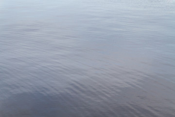 Surface of water under a cloudy sky in summer